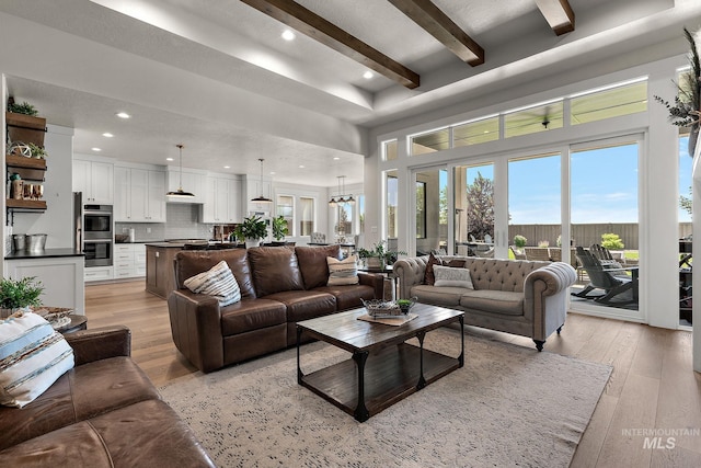 5209 W Strant Steet, Eagle, ID 83616 - living area featuring a high ceiling, light wood finished floors, beam ceiling, and recessed lighting