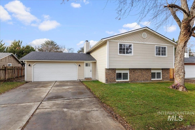 split level home featuring a front lawn and a garage