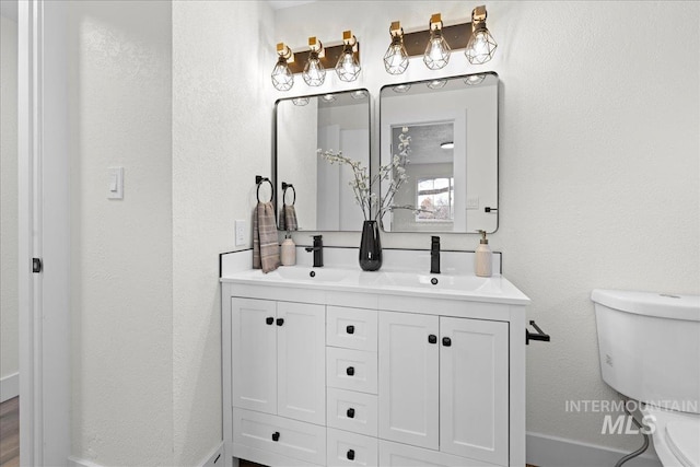 bathroom featuring vanity and toilet