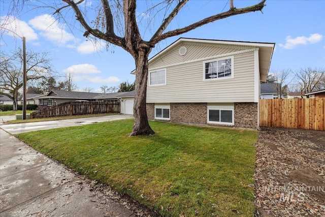 view of front of property featuring a garage and a front lawn