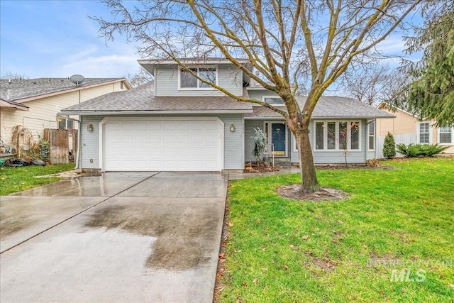 view of front of home with a front lawn and a garage