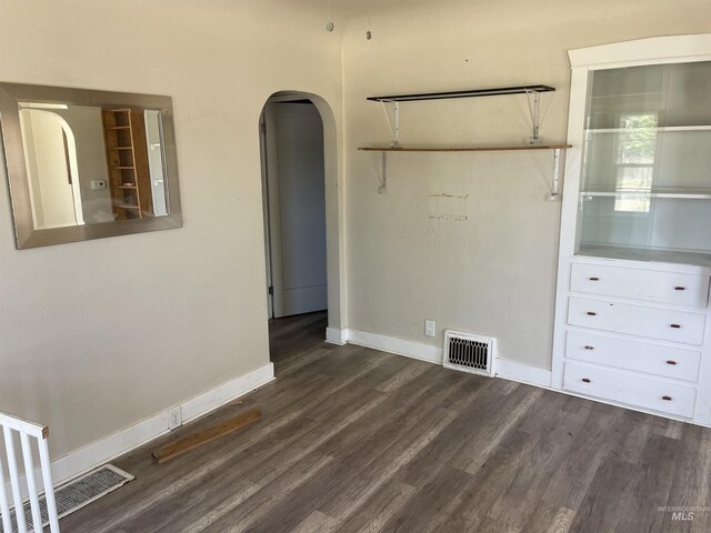 512 19th Ave S, Nampa, ID 83651 - empty room with dark wood-style floors, arched walkways, and baseboards