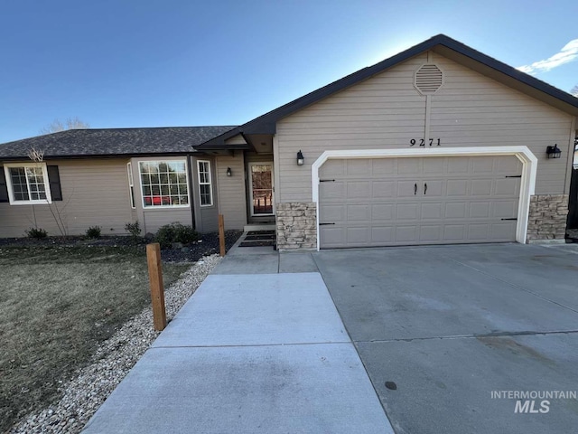 single story home featuring an attached garage, roof with shingles, stone siding, and concrete driveway
