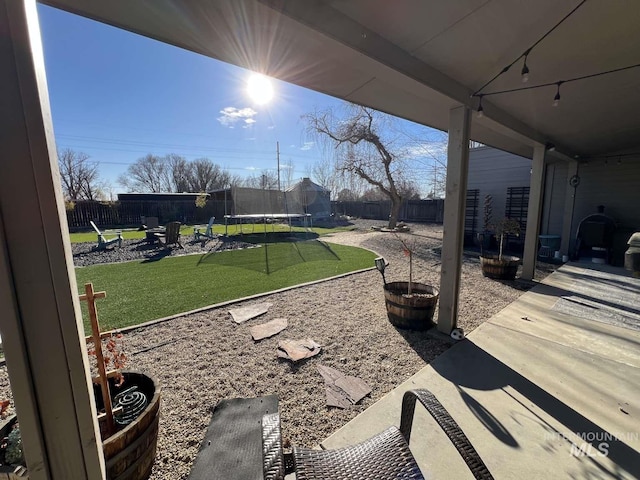 view of patio / terrace featuring a fenced backyard and a trampoline