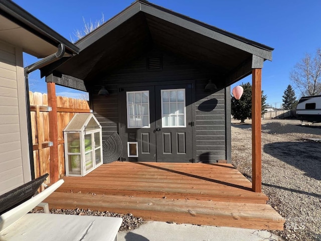 doorway to property featuring a wooden deck and fence