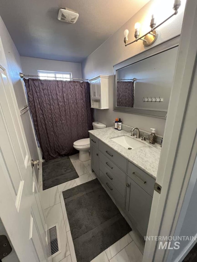 bathroom with visible vents, marble finish floor, and toilet