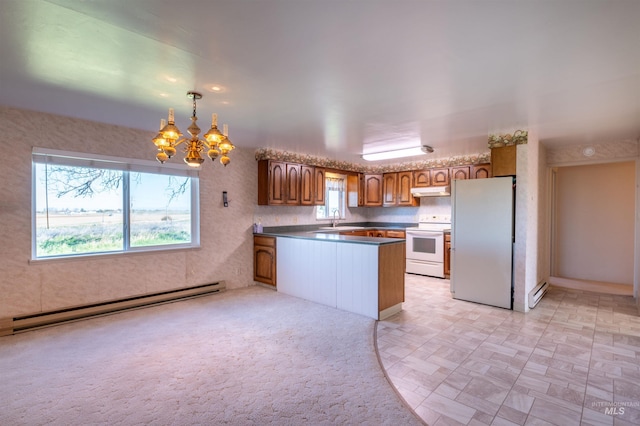 50 S 200 W, Jerome, ID 83338 - kitchen featuring white appliances, a baseboard radiator, brown cabinetry, a notable chandelier, and a peninsula