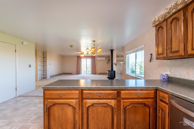 50 S 200 W, Jerome, ID 83338 - kitchen featuring dark countertops, a peninsula, stainless steel dishwasher, and a wood stove