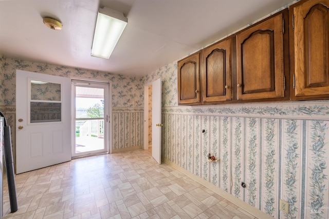 50 S 200 W, Jerome, ID 83338 - interior space featuring wallpapered walls, light floors, and brown cabinets