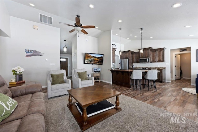 living area featuring visible vents, ceiling fan, recessed lighting, wood finished floors, and high vaulted ceiling