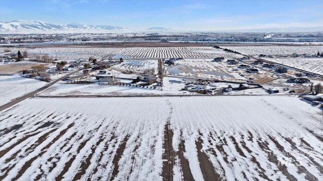 snowy aerial view with a mountain view