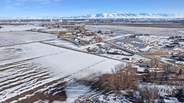 snowy aerial view with a mountain view