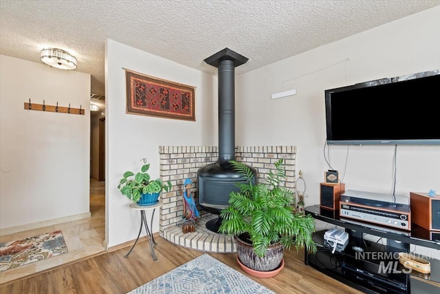 details featuring a textured ceiling, wood finished floors, and a wood stove