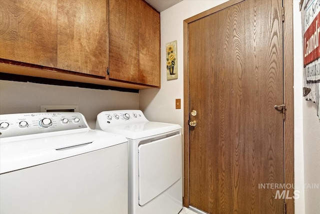 laundry room with washing machine and dryer and cabinet space