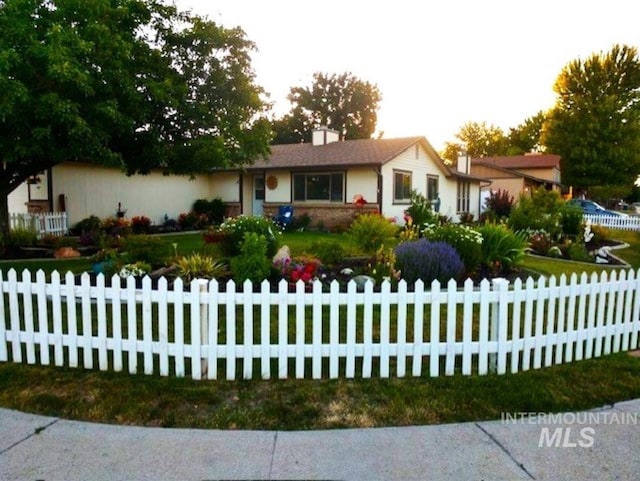 ranch-style home with a fenced front yard