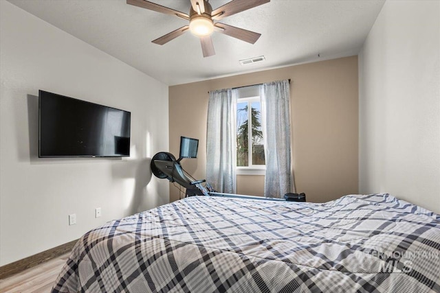 bedroom with ceiling fan and light wood-type flooring