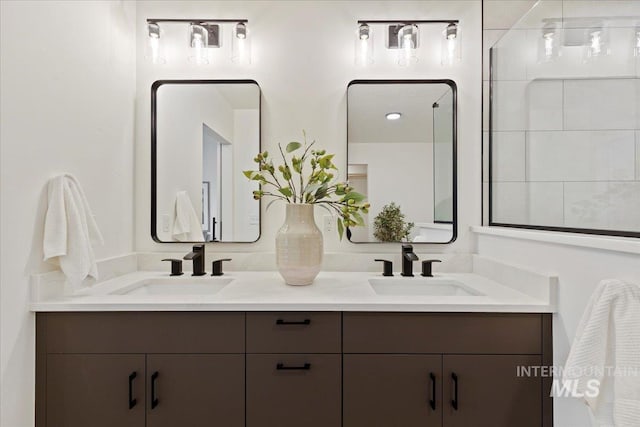 full bathroom with double vanity and a sink