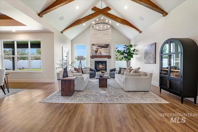3160 Crescent Moon Rd, Twin Falls, ID 83301 - living area with beamed ceiling, wood finished floors, plenty of natural light, a fireplace, and high vaulted ceiling