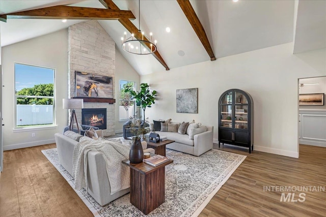 3160 Crescent Moon Rd, Twin Falls, ID 83301 - living room with high vaulted ceiling, beamed ceiling, a stone fireplace, wood finished floors, and recessed lighting
