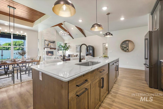 3160 Crescent Moon Rd, Twin Falls, ID 83301 - kitchen featuring stainless steel appliances, light wood finished floors, a stone fireplace, pendant lighting, and recessed lighting