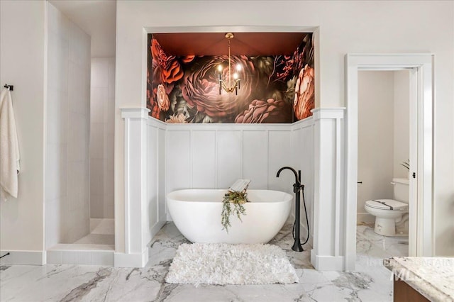 3160 Crescent Moon Rd, Twin Falls, ID 83301 - bathroom with marble tiled floors, a freestanding bath, vanity, tiled shower, and a decorative wall