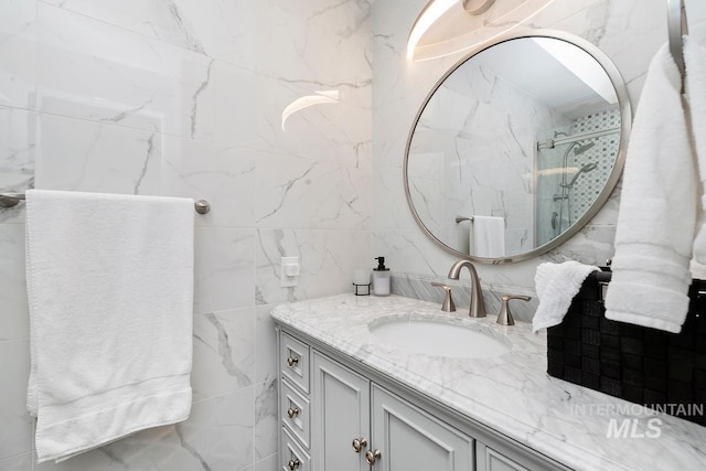 7913 W War Bonnet Dr, Boise, ID 83709 - full bath featuring a shower stall, tile walls, and vanity
