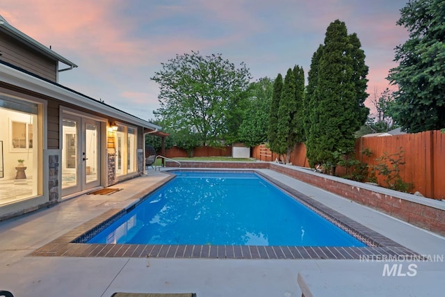 7913 W War Bonnet Dr, Boise, ID 83709 - view of swimming pool featuring french doors, a fenced backyard, and a patio