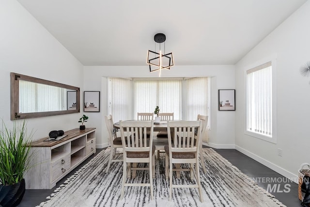 7913 W War Bonnet Dr, Boise, ID 83709 - dining room with lofted ceiling, a chandelier, baseboards, and wood finished floors