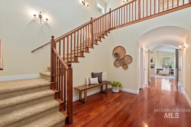 187 E Wishbone Ct, Boise, ID 83706 - stairway with arched walkways, wood finished floors, baseboards, and a towering ceiling