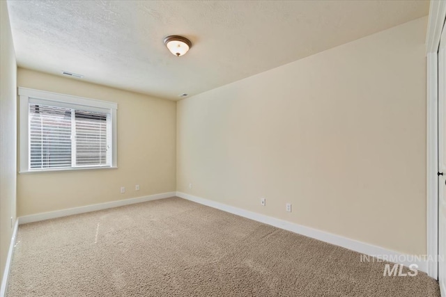 187 E Wishbone Ct, Boise, ID 83706 - unfurnished room with carpet floors, baseboards, and a textured ceiling