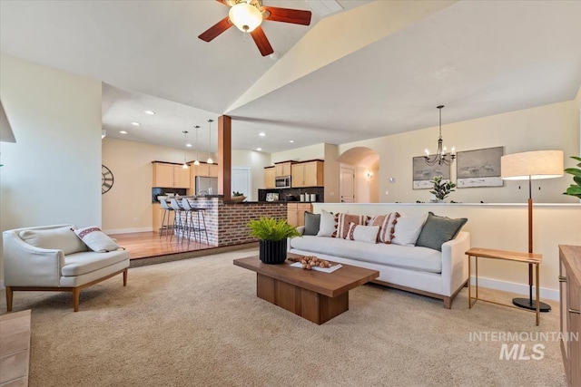 187 E Wishbone Ct, Boise, ID 83706 - living room with arched walkways, light colored carpet, a chandelier, a ceiling fan, and vaulted ceiling