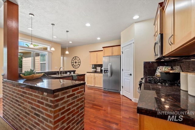 187 E Wishbone Ct, Boise, ID 83706 - kitchen featuring appliances with stainless steel finishes, dark wood-style floors, recessed lighting, a sink, and pendant lighting