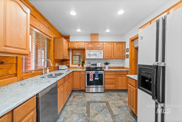 14 Sunrise Dr, Garden Valley, ID 83622 - kitchen with stainless steel appliances, light stone counters, a sink, and recessed lighting