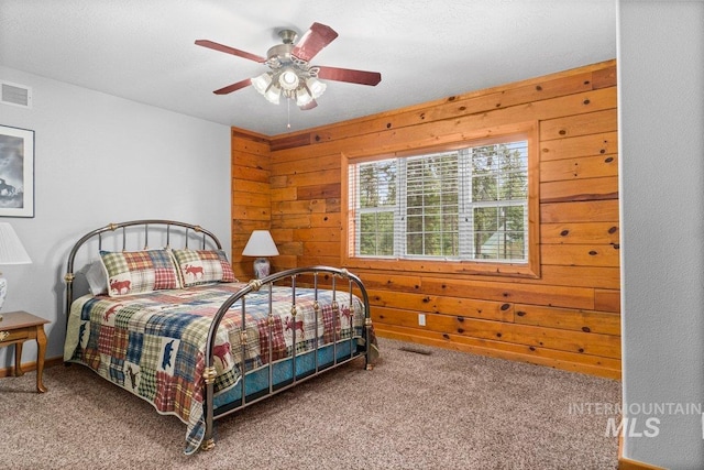 14 Sunrise Dr, Garden Valley, ID 83622 - bedroom featuring carpet flooring, ceiling fan, wood walls, and visible vents