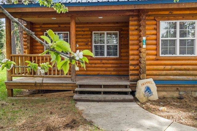 14 Sunrise Dr, Garden Valley, ID 83622 - doorway to property with a porch, log siding, and metal roof