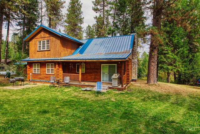 14 Sunrise Dr, Garden Valley, ID 83622 - rear view of property with log siding, a yard, metal roof, and covered porch