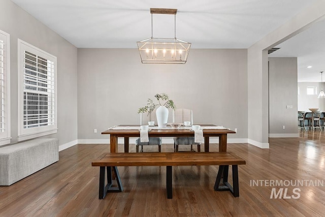 5557 E Hootowl Dr, Boise, ID 83716 - dining area featuring baseboards, wood finished floors, and a chandelier