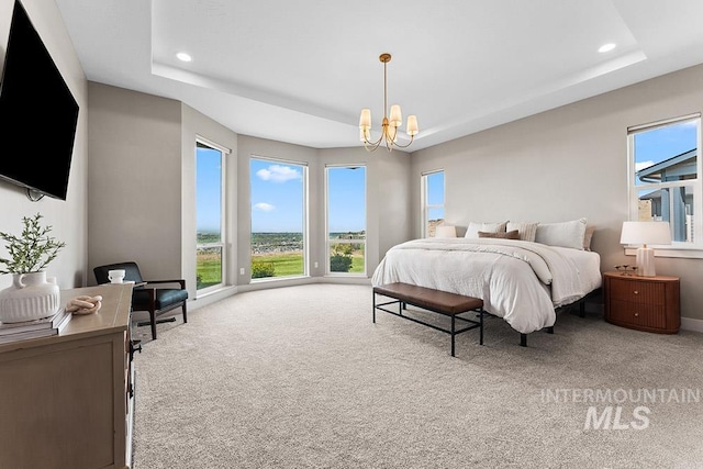 5557 E Hootowl Dr, Boise, ID 83716 - carpeted bedroom with a tray ceiling, multiple windows, recessed lighting, and a chandelier