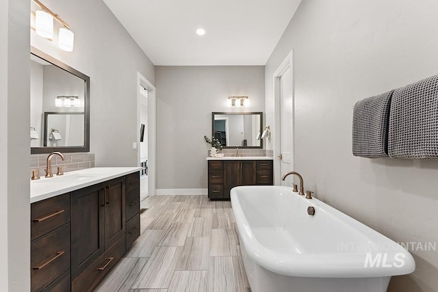 5557 E Hootowl Dr, Boise, ID 83716 - full bath featuring a soaking tub, two vanities, backsplash, and baseboards