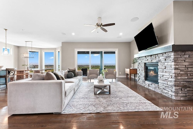 5557 E Hootowl Dr, Boise, ID 83716 - living room with a ceiling fan, dark wood-style floors, a stone fireplace, and recessed lighting