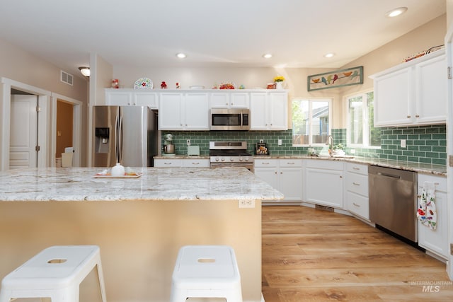 6524 S Derbyshire Ave, Boise, ID 83709 - kitchen featuring stainless steel appliances, a sink, white cabinetry, backsplash, and recessed lighting