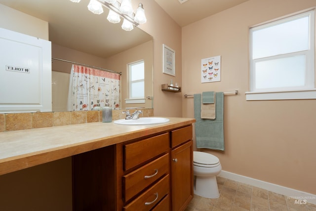6524 S Derbyshire Ave, Boise, ID 83709 - bathroom with baseboards, toilet, vanity, and a shower with shower curtain