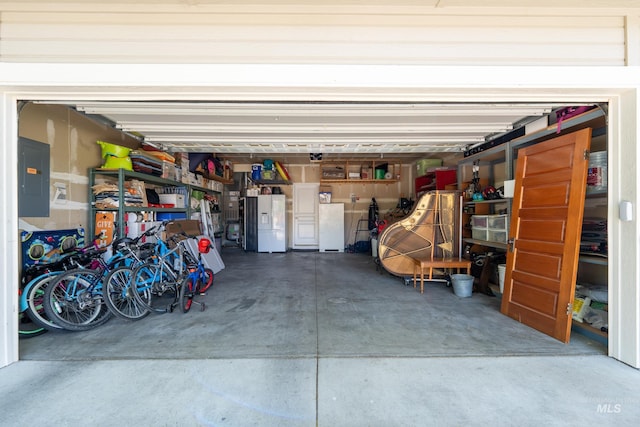6524 S Derbyshire Ave, Boise, ID 83709 - garage featuring freestanding refrigerator, electric panel, and white refrigerator with ice dispenser