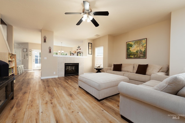 6524 S Derbyshire Ave, Boise, ID 83709 - living room featuring light wood finished floors, a ceiling fan, a fireplace, and baseboards