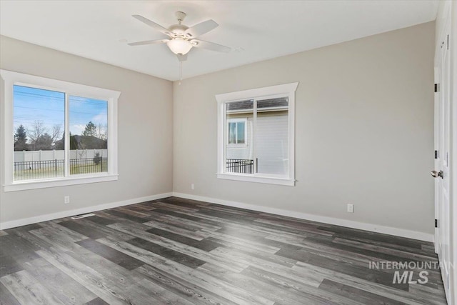 unfurnished room featuring dark hardwood / wood-style floors and ceiling fan