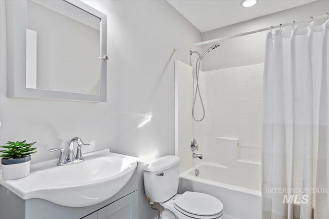 full bathroom featuring toilet, vanity, and shower / tub combo with curtain