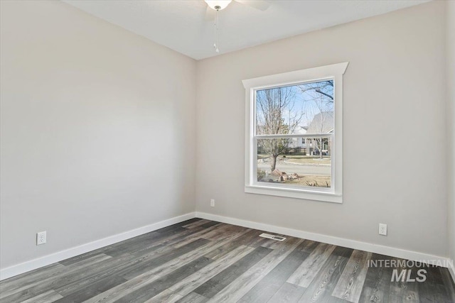 empty room featuring dark hardwood / wood-style flooring