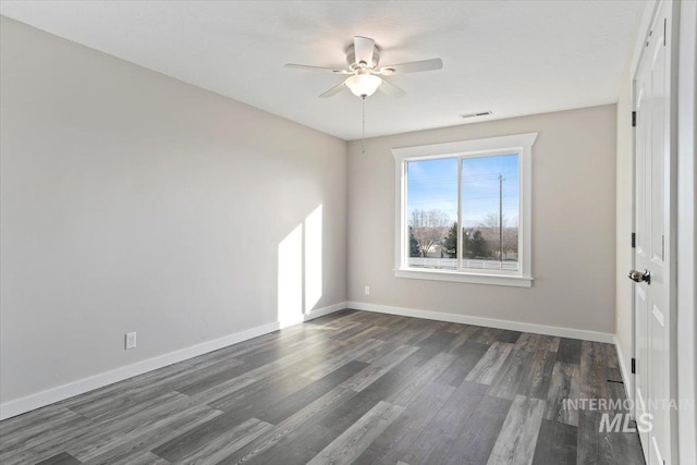 empty room with ceiling fan and dark hardwood / wood-style floors