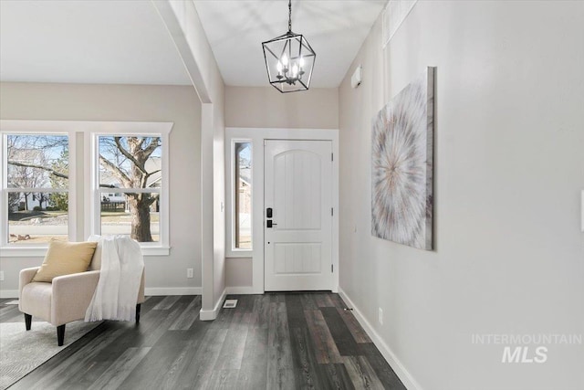 foyer with an inviting chandelier and dark hardwood / wood-style floors