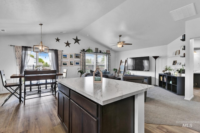 kitchen with ceiling fan, dark brown cabinetry, visible vents, light countertops, and lofted ceiling